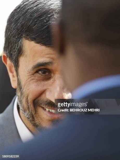 Iranian President Mahmoud Ahmadinejad greets a member of the Comoran delegation visiting with Comoran President Ahmed Abdallah Mohamed Sambi during a...