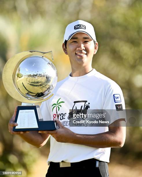Taichi Nabetani of Japan poses with the trophy after winning the Casio World Open Golf Tournament at Kochi Kuroshio Country Club in Kochi Prefecture,...