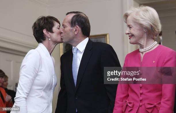 Tony Abbott receives a kiss from his wife Margie after being sworn in as the 28th Prime Minister of Australia by the Governor-General Quentin Bryce...