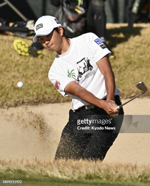 Taichi Nabetani of Japan hits out of a bunker on the 18th hole during the final round of the Casio World Open Golf Tournament at Kochi Kuroshio...