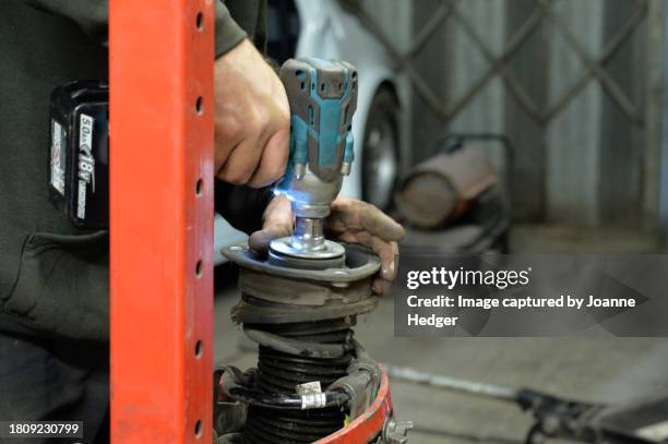 technician repairs automobile shock absorbers - car suspension stock pictures, royalty-free photos & images
