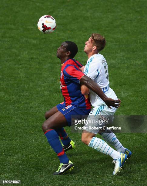 Emile Heskey of the Jets is is challenged by Nicholas Ansell of the Victory during the A-League friendly match between the Melbourne Victory and the...