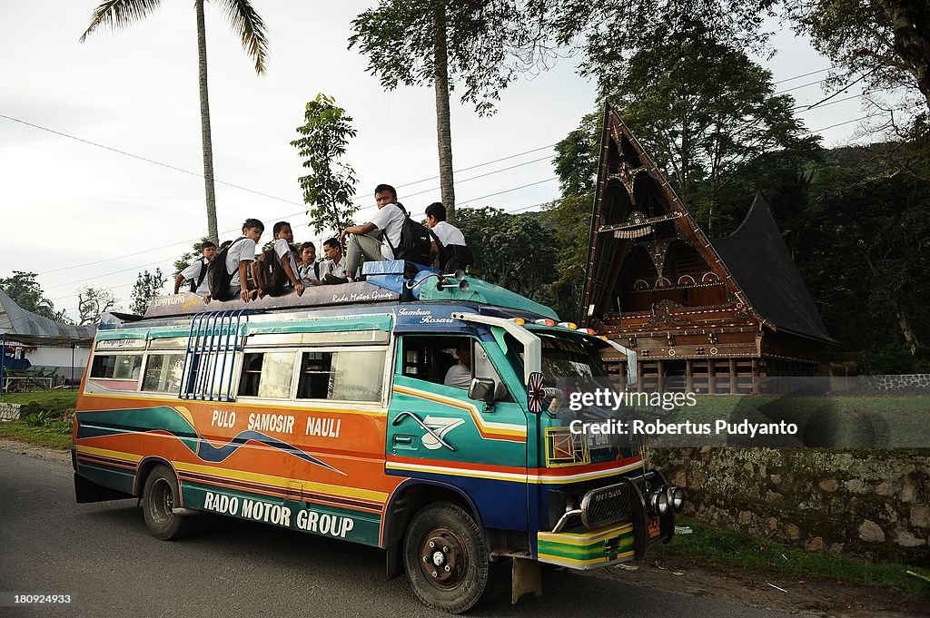Indonesian Students Ride Atop Buses On The School Run