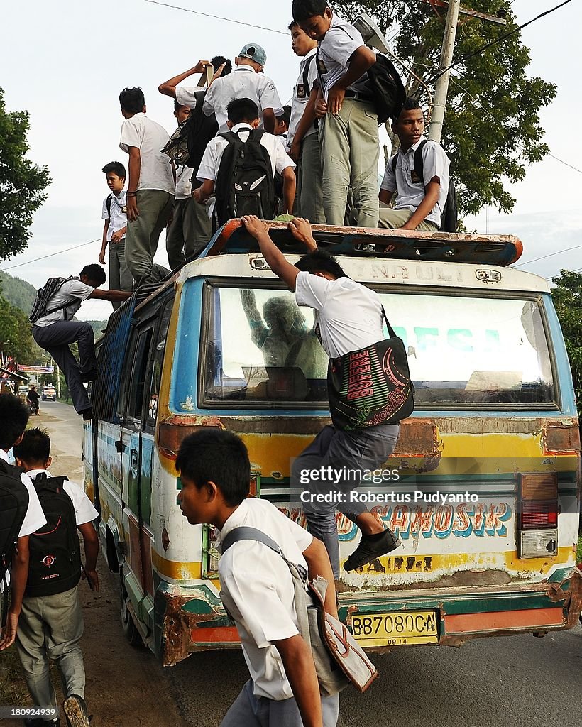 Indonesian Students Ride Atop Buses On The School Run