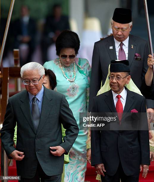 Singapore's President Tony Tan Keng Yam and Malaysia's King Abdul Halim Mu'adzam Shah walk with Malaysian Prime Minister Najib Razak and wife Rosmah...