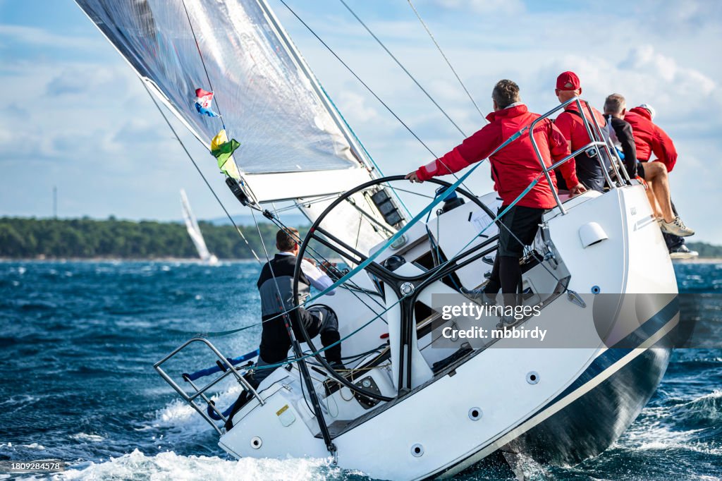Sailing crew on sailboat on regatta
