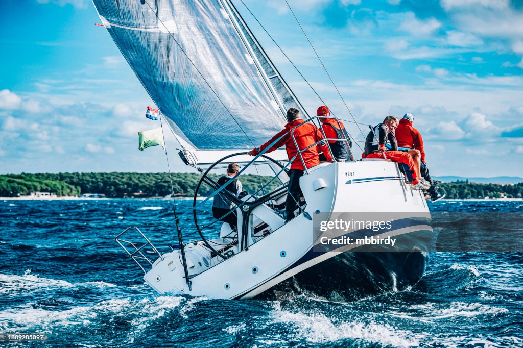 Sailing crew on sailboat on regatta