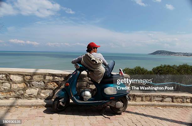 Young man enjoys the view of the coast of Tunis on September 4, 2013.