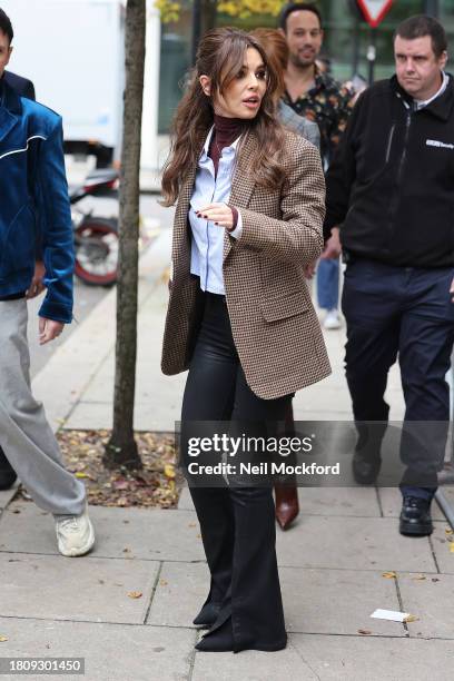 Cheryl signing autographs for fans outside BBC Radio 2 after they announce the comeback of Girls Aloud on November 23, 2023 in London, England.