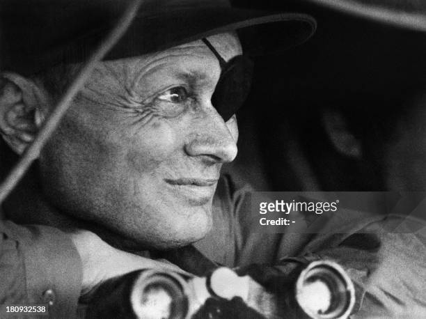 Israeli defence minister General Moshe Dayan watches on October 18, 1973 the Syrian lines on the Golan Heights, during the 1973 ArabIsraeli War. On...