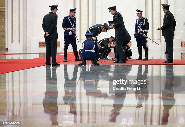 Members of an honour guard use tape measures on the floor to line up as they prepare for a welcoming ceremony for King Abdullah II Ibn Al Hussein of...