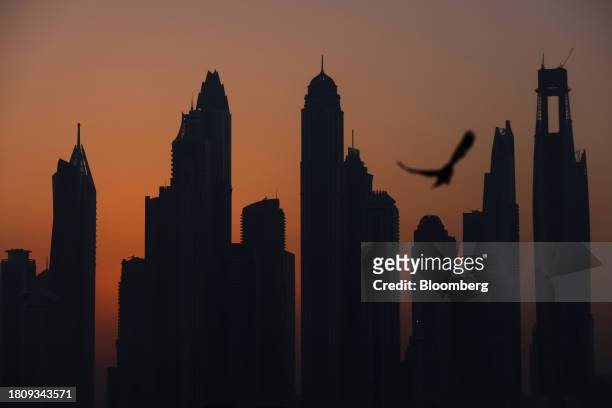 The sun rises behind skyscrapers on the city skyline in Dubai, United Arab Emirates, on Wednesday, Nov. 29, 2023. More than 70,000 politicians,...