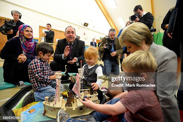 First Minister Alex Salmond and Deputy First Minister Nicola Sturgeon talk to children during a visits to the North Edinburgh Childcare Centre to...