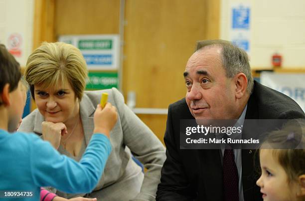 First Minister Alex Salmond and Deputy First Minister Nicola Sturgeon talk to children during a visits to the North Edinburgh Childcare Centre to...