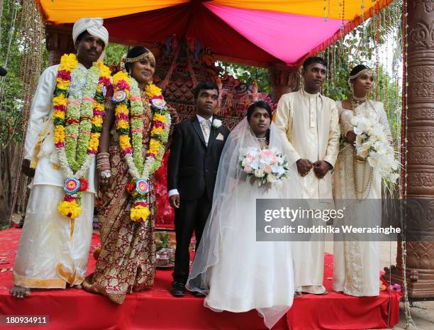 Former female Tamil rebel, Premarathnam Suganthini , 19 years old, and her groom H.N. Rathnayaka, 23 years old, attend a group photograph with...