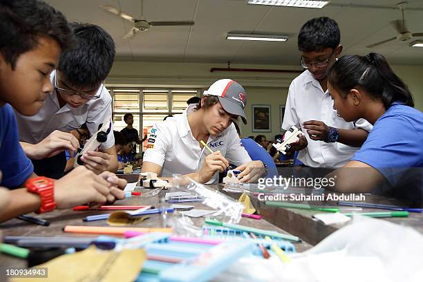 Esteban Gutierrez of Mexico and Sauber F1 joins local youth from the Chelsea FC Soccer School Singapore and Henderson Secondary School to build a...