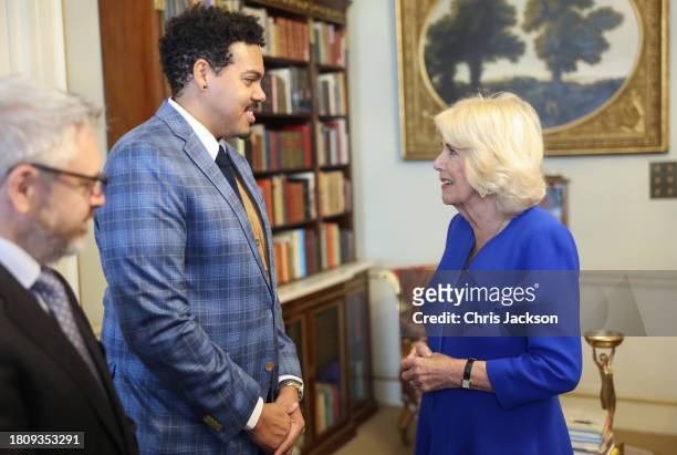 Queen Camilla speaks with author Jonathan Escoffery, who is nominated for "If I Survive You" during the Booker Prize Foundation reception at Clarence...