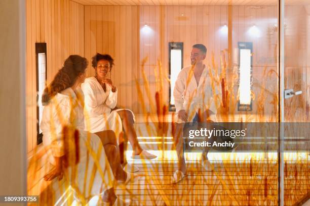 multiracial friends relaxing in the sauna - infrared stockfoto's en -beelden