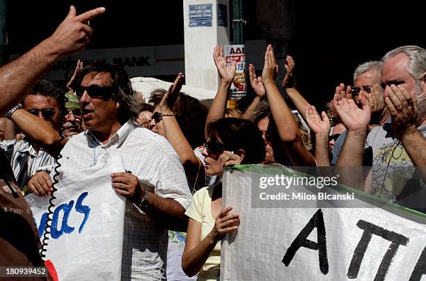 Protestors hold banners during a demonstration against austerity and job cuts on September 18, 2013 in Athens, Greece. As part of the redeployment...