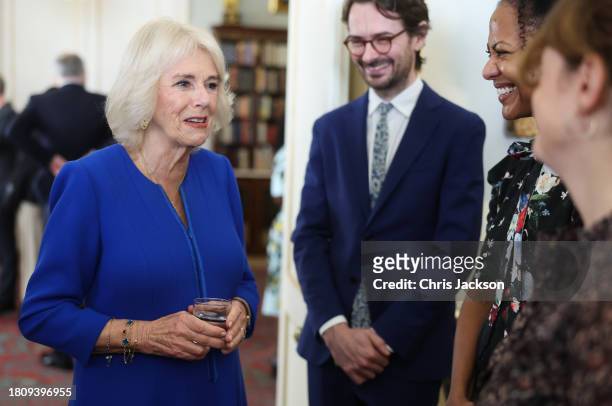 Queen Camilla shares a joke with guests during the Booker Prize Foundation reception at Clarence House on November 23, 2023 in London, England.