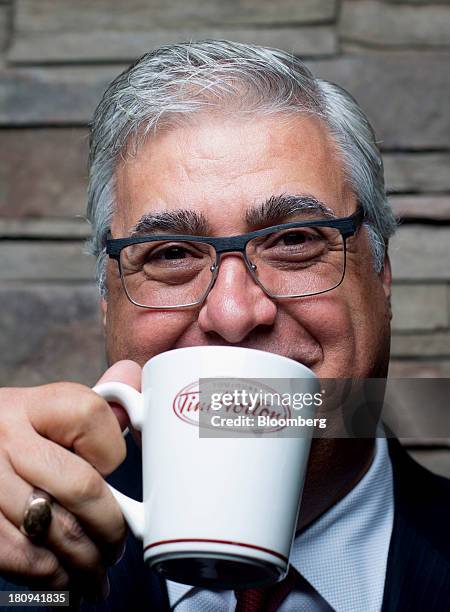 Marc Caira, president and chief executive officer of Tim Hortons Inc., stands for a photograph after an interview at a Tim Horton's restaurant in...
