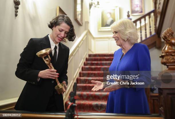 Queen Camilla and Gaby Wood, Director of the Booker Prize Foundation share a joke during the Booker Prize Foundation reception at Clarence House on...