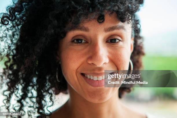 close-up front shot of young african american woman looking at camera - dark skin tone stock pictures, royalty-free photos & images