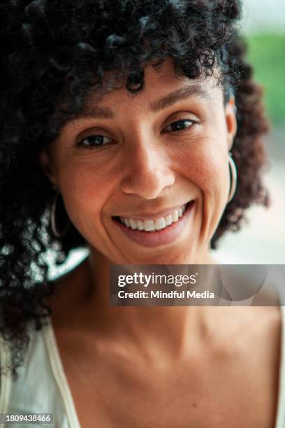 medium shot front view of young african american woman looking at camera - dark skin tone stock pictures, royalty-free photos & images