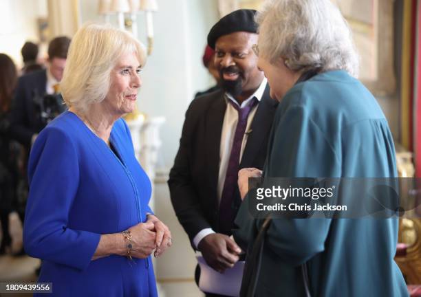 Queen Camilla speaks to a guest during the Booker Prize Foundation reception at Clarence House on November 23, 2023 in London, England.