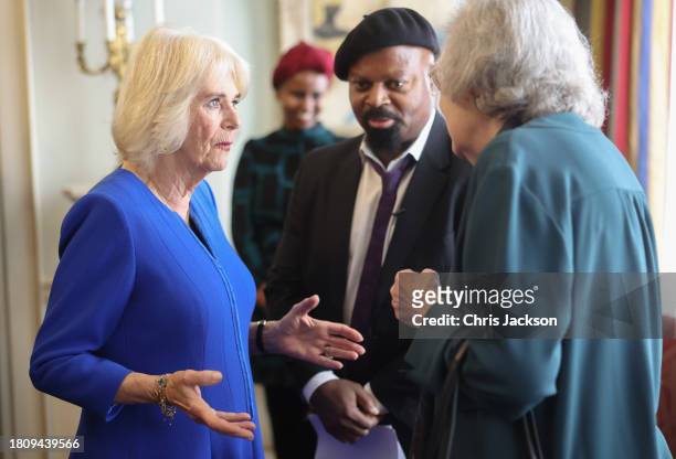 Queen Camilla speaks to a guest during the Booker Prize Foundation reception at Clarence House on November 23, 2023 in London, England.