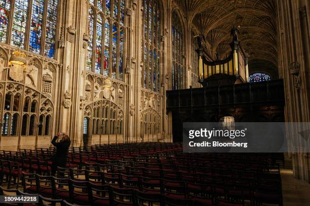 Tourist takes a photograph inside King's College Chapel at Cambridge University in Cambridge, UK, on Tuesday, Nov. 28, 2023. The installation of 438...
