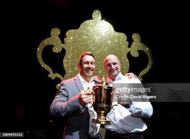 Jonny Wilkinson and Mike Catt pose with the Webb Ellis trophy during the 2003 England Rugby World Cup winning squad reunion at the Eventim Apollo on...