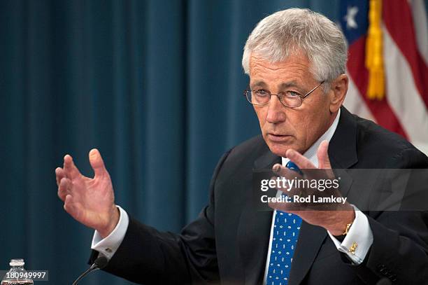 Secretary of Defense Chuck Hagel responds to a question from a reporter as he and Chairman of the Joint Chiefs of Staff Gen. Martin E. Dempsey brief...