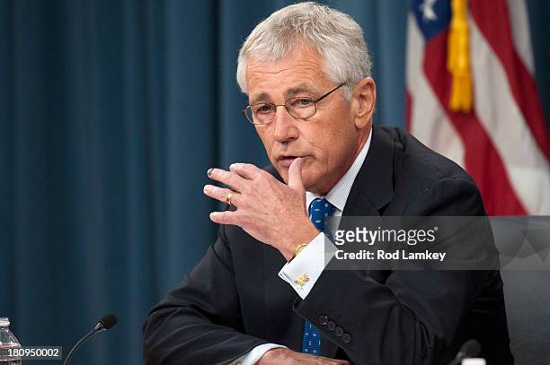 Secretary of Defense Chuck Hagel responds to a question from a reporter as he and Chairman of the Joint Chiefs of Staff Gen. Martin E. Dempsey brief...