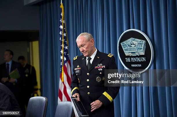 Chairman of the Joint Chiefs of Staff Gen. Martin E. Dempsey arrives to brief the press at the Pentagon, September 18, 2013 in Arlington, Virginia....