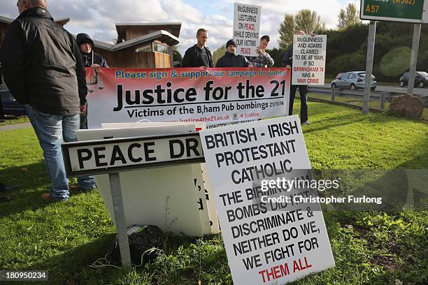 Protesters campaigning for justice for the victims of the Birmingham bombings stand wih placards outside the Tim Parry Johnathan Ball Foundation for...