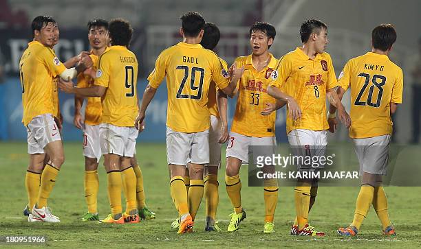 China's Guangzhou Evergrande players celebrate after winning their AFC Championship league football match against Qatar's Lekhwiya club at the...