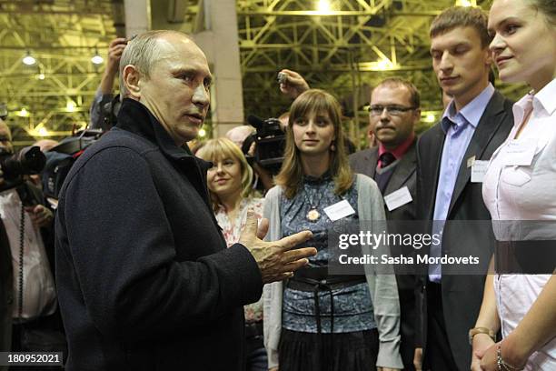 Russian President Vladimir Putin talks to workers during his visit to the Kalashnikov manufacturing plant September 18, 2013 in Izhevsk, Russia. The...