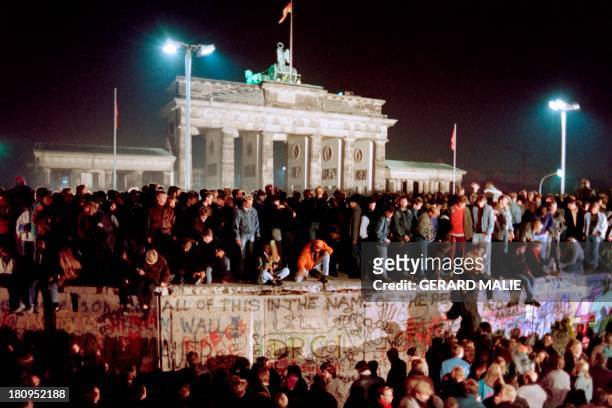 Thousands of young East Berliners crowd atop the Berlin Wall, near the Brandenburg Gate on November 11, 1989. Two days before, Gunter Schabowski, the...