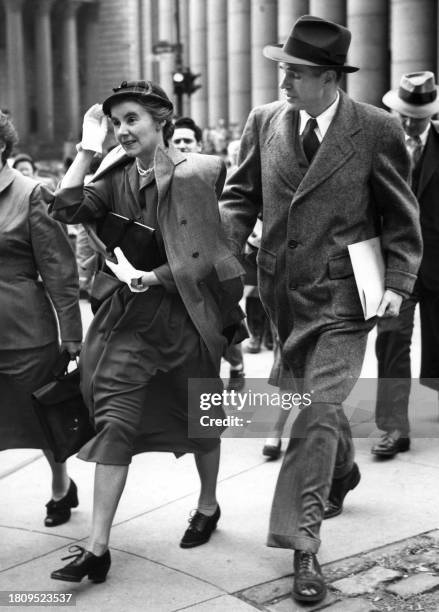 Former State Department official Alger Hiss and his wife leave the Federal Court 13 October 1950 after the opening hearing, before the court of...