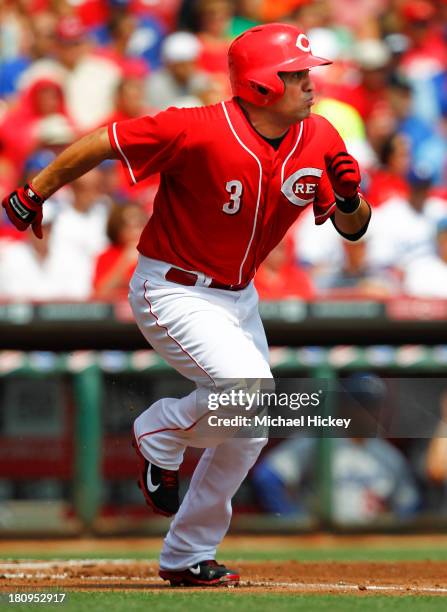 Cesar Izturis of the Cincinnati Reds runs to first base during the first inning against the Los Angeles Dodgers at Great American Ball Park on...