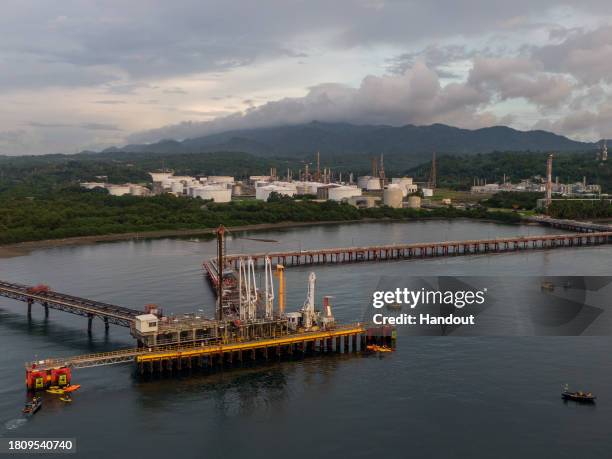 In this handout image provided by Greenpeace, Greenpeace flagship the Rainbow Warrior and Filipino climate activists on kayaks block access to the...