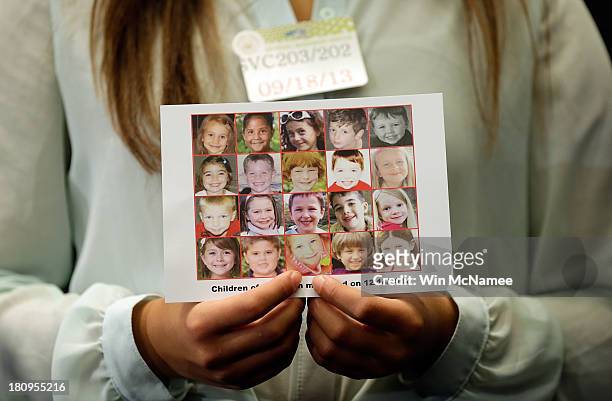 Kyra Murray holds a photo with victims of the shooting at Sandy Hook Elementary School during a press conference at the U.S. Capitol calling for gun...