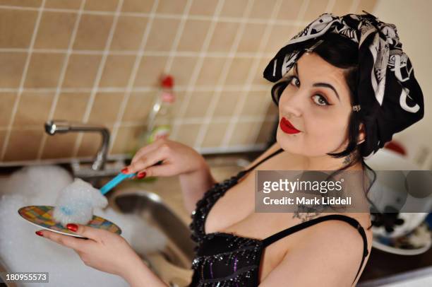 pin-up girl washing dishes at a sink - pin up girl tattoo stock pictures, royalty-free photos & images