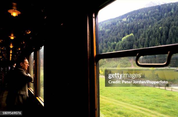 Passengers view the passing scenery aboard the Orient Express luxury train service, operating between Paris, France and Budapest in Hungary on 13th...