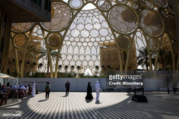 Attendees pass the Al Wasl dome in the Blue Zone ahead of the COP28 climate conference at Expo City in Dubai, United Arab Emirates, on Wednesday,...
