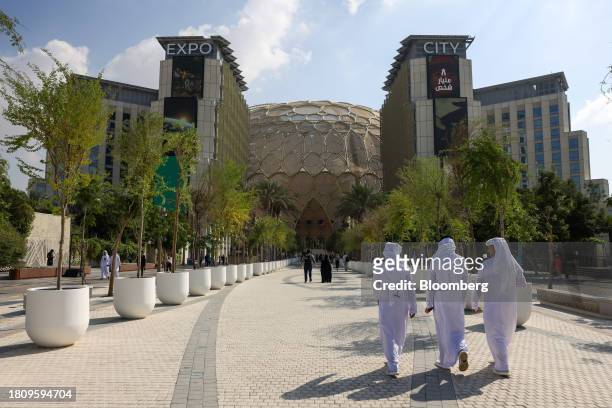 Attendees walk through the campus in the Blue Zone ahead of the COP28 climate conference at Expo City in Dubai, United Arab Emirates, on Wednesday,...