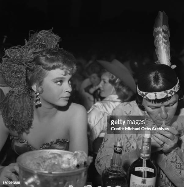 Singer and actor Frank Sinatra and girlfriend Juliet Prowse attend the SHARE Boomtown benefit party at the Moulin Rouge on May 13, 1960 in Los...