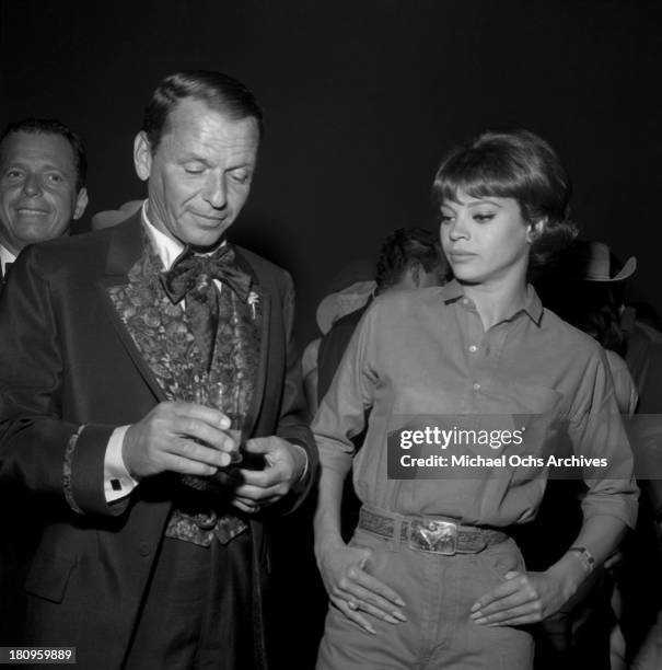 Singer and actor Frank Sinatra and fiance Juliet Prowse attend the SHARE Boomtown benefit party in 1963 in Los Angeles, California.