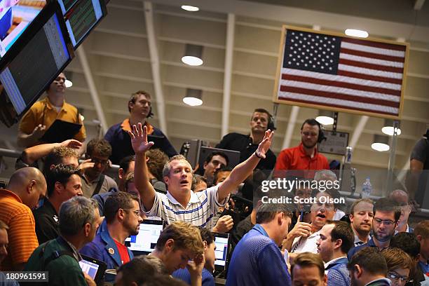 Traders in the Standard & Poor's 500 stock index options pit at the Chicago Board Options Exchange signal offers as they wait for the Federal Open...